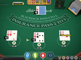Et grønt bord med tre hænder, hvoraf den ene hånd har blackjack